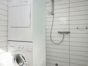 a white washer and dryer in a bathroom at Three-Bedroom Holiday home in Knebel 22 in Knebel