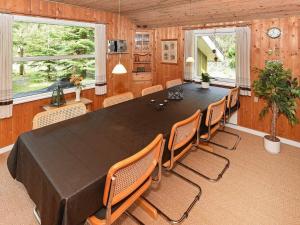 a large dining room with a large table and chairs at 8 person holiday home in N rre Nebel in Lønne Hede