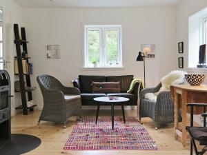 a living room with a couch and chairs and a table at 5 person holiday home in Harbo re in Harboør