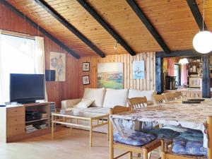 a living room with a couch and a table at Three-Bedroom Holiday home in Lemvig 8 in Lemvig