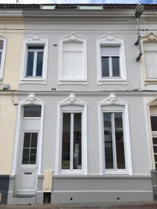 a white building with white windows and doors at LocationsTourcoing - Le Famelart in Tourcoing