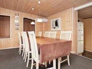 jadalnia ze stołem i białymi krzesłami w obiekcie Holiday home Ebeltoft XII w mieście Ebeltoft
