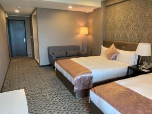 Postel nebo postele na pokoji v ubytování Chi Shing Hai Hotel