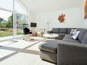 a living room with a couch and a table at 6 person holiday home in Nykøbing Sj-By Traum in Tjørneholm