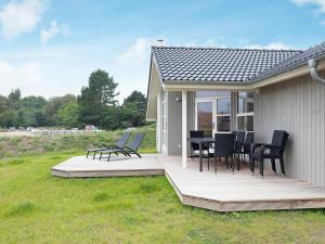 a deck with chairs and a table on a house at Holiday home Großenbrode XXV in Großenbrode