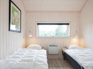 Tempat tidur dalam kamar di Holiday home Großenbrode XXXI