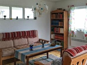 a living room with a couch and a table at 3 person holiday home in FJ LKINGE in Fjälkinge
