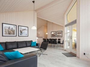 a living room with a couch and a table and chairs at 10 person holiday home in Gro enbrode in Großenbrode