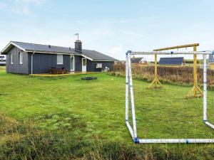a volley ball hoop in a yard with a house at 6 person holiday home in Lemvig in Ferring