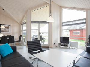 a living room with a couch and a table with chairs at 10 person holiday home in Gro enbrode in Großenbrode