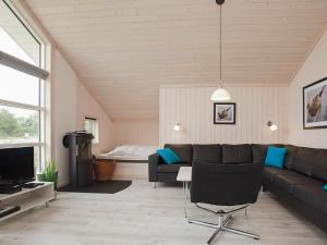 a living room with a couch and a television at 8 person holiday home in Gro enbrode in Großenbrode