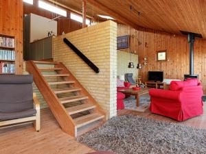 a living room with a brick wall and a staircase at 8 person holiday home in Asn s in Asnæs