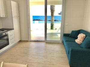 a living room with a couch and a view of the ocean at Sea House Tonnara in Sciacca +30 photos