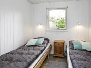 Postel nebo postele na pokoji v ubytování Holiday home Jerup IX