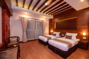 a hotel room with two beds and a chair at Sunshine Boutique Hotel in Kathmandu