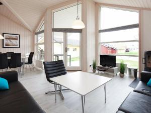 a living room with a white table and chairs at 8 person holiday home in Gro enbrode in Großenbrode