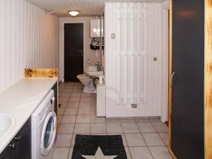a bathroom with a washing machine and a toilet at 6 person holiday home in Hemmet in Hemmet