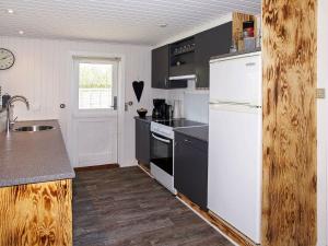 a kitchen with a white refrigerator and a sink at 6 person holiday home in Hemmet in Hemmet