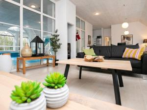 uma sala de estar com um sofá e uma mesa de centro em 16 person holiday home in Ulfborg em Ulfborg