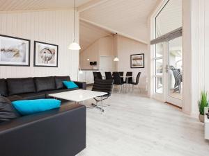 a living room with a couch and a table at 8 person holiday home in Gro enbrode in Großenbrode