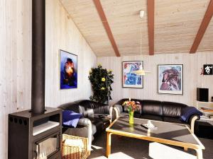 a living room with a couch and a fireplace at 10 person holiday home in Fan in Fanø