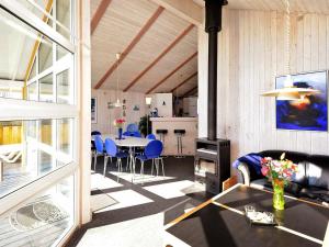 sala de estar con mesa y sillas azules en 10 person holiday home in Fan en Fanø