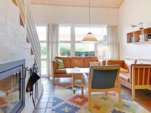 a living room with a couch and a table at Holiday Home Fyrvej VI in Blåvand