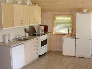a kitchen with white appliances and a white refrigerator at 6 person holiday home in Hemmet in Falen