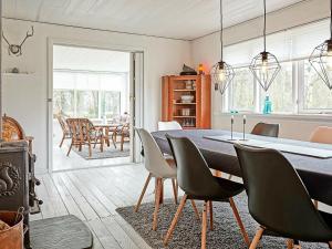 a kitchen and dining room with a table and chairs at Holiday home Hasle III in Hasle