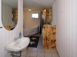 a bathroom with a sink and a bath tub at 6 person holiday home in Hemmet in Hemmet