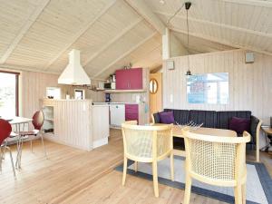 a kitchen and living room with a table and chairs at 8 person holiday home in Oksb l in Vejers Strand