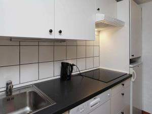 a kitchen with a sink and a counter top at 5 person holiday home in Bl vand in Blåvand