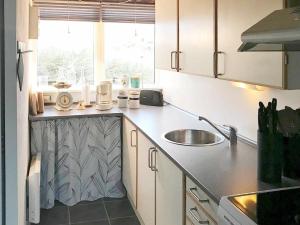 a kitchen with a sink and a counter top at 6 person holiday home in Ringk bing in Klegod