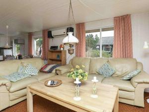 a living room with a couch and a coffee table at 6 person holiday home in Ulfborg in Sønder Nissum