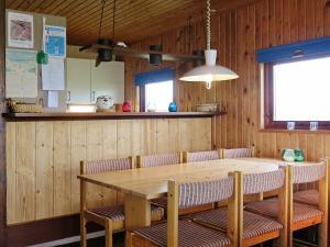 a dining room with a wooden table and chairs at 8 person holiday home in Harbo re in Harboør