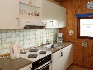 a kitchen with a sink and a stove top oven at 8 person holiday home in Harbo re in Harboør