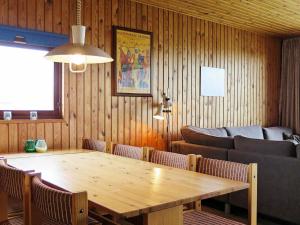a dining room with a wooden table and chairs at 8 person holiday home in Harbo re in Harboør