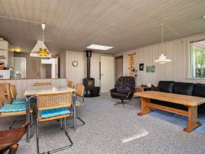 a living room with a couch and a table at 8 person holiday home in Hurup Thy in Sindrup
