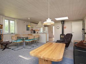 a living room with a wooden table and chairs at 8 person holiday home in Hurup Thy in Sindrup