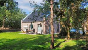 a brick house with a patio and trees at Fehmarn Mein Urlaub in Fehmarn