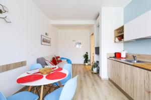 uma cozinha e uma sala de estar com mesa e cadeiras em 34 Via Giulio Carcano em Milão