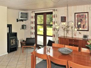 a living room with a wooden table and a fireplace at 8 person holiday home in N rre Nebel in Nørre Nebel