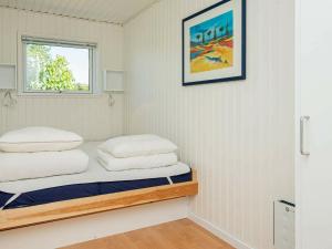 a room with a bed with two pillows on it at Holiday home Knebel XI in Knebel