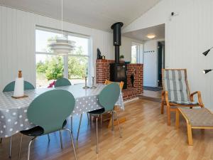a dining room with a table and chairs at Holiday home Knebel XI in Knebel