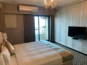 Postel nebo postele na pokoji v ubytování Chi Shing Hai Hotel
