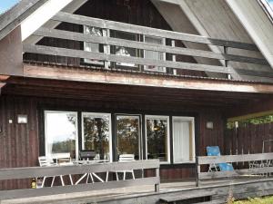 a porch of a house with chairs and windows at 5 person holiday home in L GDE in Himmersundet