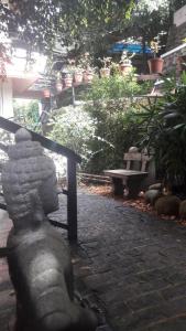 a statue of a person sitting on a stone path at Shamrock Holiday Home in Munnar