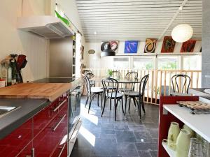 a kitchen with a table and chairs in it at 5 person holiday home in RYSSBY in Ryssby