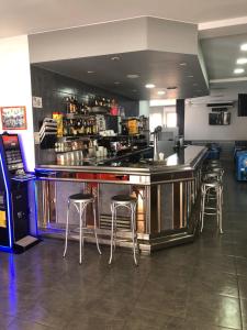 a bar in a restaurant with stools around it at hostal trevol in Torelló