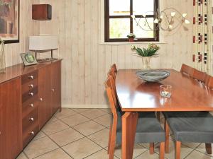 a dining room with a wooden table and chairs at 8 person holiday home in N rre Nebel in Nørre Nebel